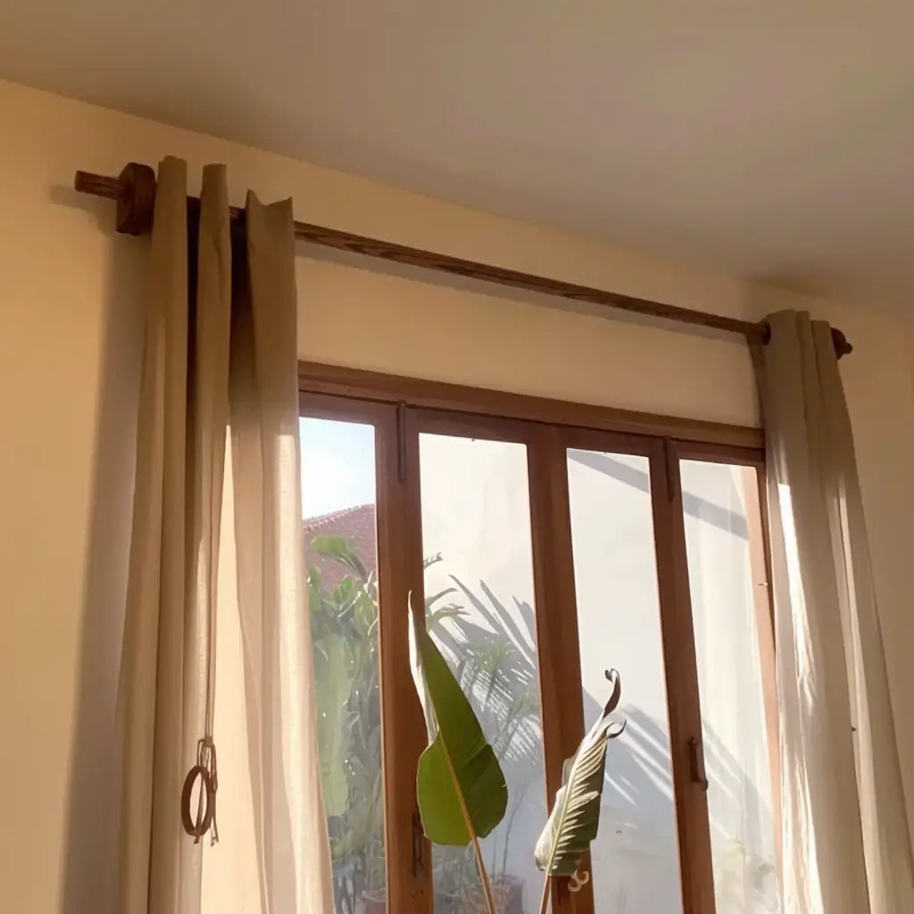 Natural wood curtain rod with ring clips and classic fabric